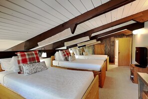 A cozy attic bedroom with two beds, wooden beams, and a television. - 🌲Timberline A3D Deluxe 2-Bedroom + Loft ~ 3/bath ~Hot Tub~Pool~WiFi~Ski-in/out~Local Shuttle🌲 (Snowmass Village)