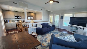 A compact living space with a kitchen, dining area, and seating area. - Daydreamer:  Reverse floorplan home offering three master bedrooms. (Ocracoke)