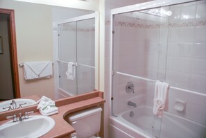 A bathroom with a sink, mirror, and a glass-enclosed shower. - Stoney Creek Lagoons 5 (Whistler)