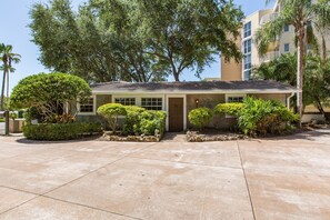 Stylish single-story residence with a front entrance and lush green surroundings.