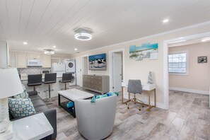 Relax in a spacious living area with a sofa, dining table, and fully equipped kitchen.