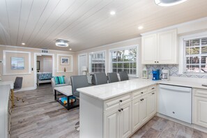Enjoy cooking and dining in this well-equipped kitchen with a central island, dishwasher, and coffee maker.