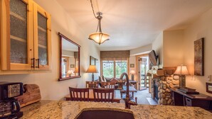 A kitchen with granite countertops, a built-in sink, and a stone fireplace. - Beautiful one bedroom condo in the heart of the center village. (Copper Mountain)