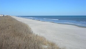 A beach with a clear sky and calm sea. -  Beautiful 4 BR Oib Condo with Beachfront Pool!  (Ocean Isle Beach)