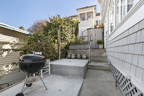 Enjoy al fresco dining on the patio, surrounded by lush greenery and a beautiful view.