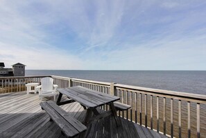 A wooden deck with a picnic table and chairs overlooking a body of water. - Waterfront/Private Pier, Water Access/Pool&Tennis club/Kayaks/SUP/ping-pong (Avon)