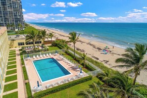 A hotel with a pool, beach view, and palm trees. - Beach Condo/ Island Beach Resort/No Cleaning Fee/ Condo 412 (Jensen Beach)