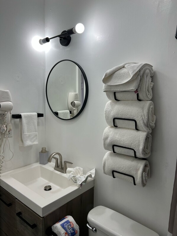 A bathroom with a sink, mirror, towel rack, and a toilet. - DESIGNER VILLA.. STUNNING. Location, location, location!!! (Rosarito,)