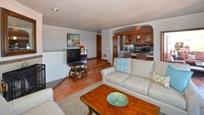 A spacious living room with a fireplace, a television, and a sofa with decorative pillows. - H319: 1BD Villa w/ Spectacular Views,Fireplace,Romantic Private Balcony,NEW Cart (Avalon)