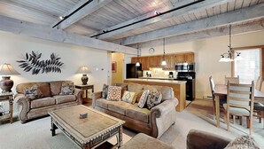 A spacious living room with two sofas, a coffee table, and a dining area with a wooden table and chairs. - 🌲Timberline D2E Deluxe 3-Bedroom ~Hot Tub~Pool~WiFi~Ski-in/out~Local Shuttle🌲 (Snowmass Village)