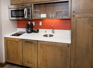 A kitchen with a stainless steel microwave, a coffee maker, and a sink. - Resort/Spa, Ski in/out, Hot Tub, 8th Fl, RmService (Avon)