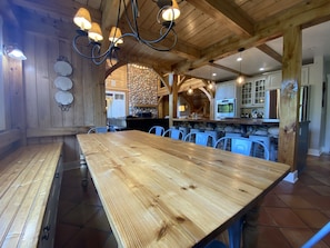 Enjoy meals in this cozy dining area with a long table and comfortable seating.