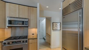 A modern kitchen with a stainless steel stove, microwave, and refrigerator. - Ski Storage, Garage and Free Shuttle (Warm Springs)