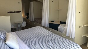 A bedroom with a large bed, a bedside table, a chair, a mirror, and a wardrobe. - Iconic Sun Valley - Parkside Village - Sleeps 7 very comfortably  (Ketchum)