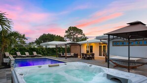 A pool area with a hot tub, lounge chairs, and a covered seating area. - SPECIALS!! BEAUTIFUL BEACH HOUSE ! WALK 2 BEACH POOL ! HOT TUB (Lauderdale-By-The-Sea)