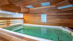 A wooden interior with a hot tub and a caution sign. - Spacious condo just steps away from main lifts, hot tub, free wifi & parking (Copper Mountain)