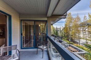 Enjoy the serene views of the neighborhood from this balcony with a glass door leading to the interior space.