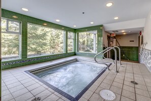 Relax by the serene pool surrounded by lush greenery and natural light.