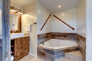 Bathtub, hair dryer, towels, shampoo