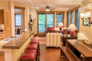 Enjoy a spacious kitchen and living area with a central island, seating, and a view of the outdoors.