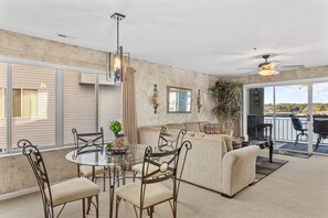 Relax in this inviting living area with a glass dining table, sofa, and comfortable seating.