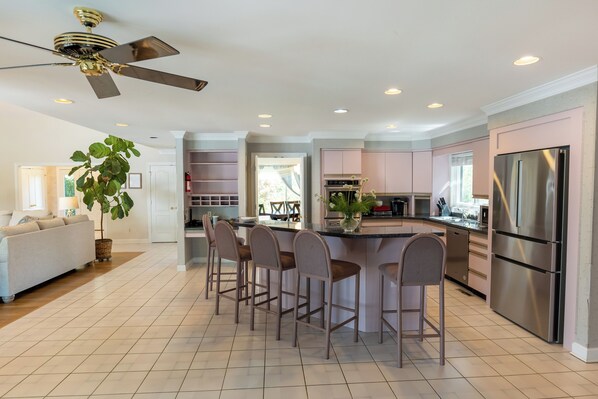 A modern kitchen with a central island, stainless steel appliances, and a ceiling fan. - 10 Person House with Private Hot tub on Spectacular Rural Estate (Castleton)