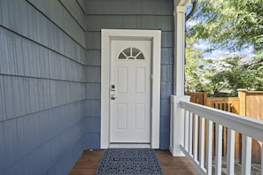 Welcome to a charming home with a welcoming entrance, complete with a decorative glass panel and a cozy doormat.