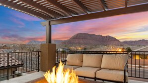 A patio with a fire pit, outdoor seating, and a view of mountains. - Awesome Arcade House: Private Hot Tub, Game Room, Theater! (Santa Clara)