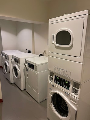 A laundry facility with multiple stacked washing machines and dryers. - Resort Ski In/Out Penthouse Studio/ Ski Valet (Avon)
