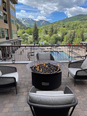 A terrace with a fire pit, outdoor seating, and a view of mountains. - Resort Ski In/Out Penthouse Studio/ Ski Valet (Avon)