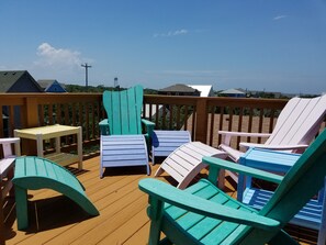 Relax on the deck with Adirondack chairs and a small table, taking in the surrounding landscape.