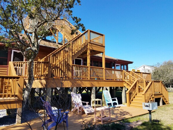 Guests can enjoy a balcony with a staircase and outdoor seating area amidst lush surroundings.