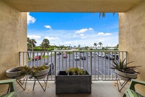 Enjoy a peaceful view of the surrounding greenery from this balcony.