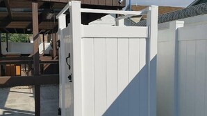 A white wooden gate in front of a building with a brown roof. - The Carters Wildwood Rentals-Suite #2 (Wildwood)