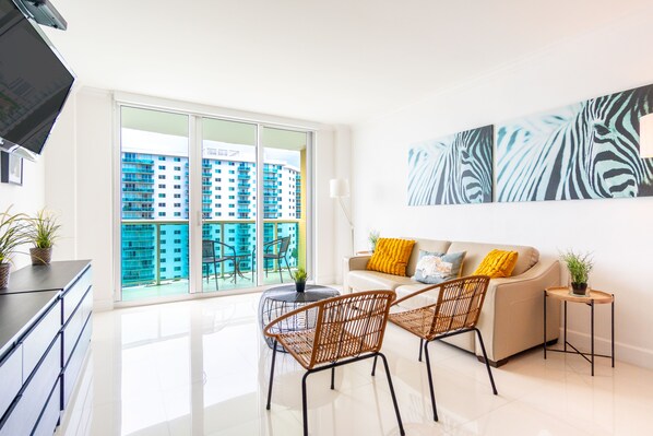 TV - Spacious condo w/ open layout across from the beach | WIFI + Parking (Sunny Isles Beach.)