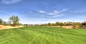 A well-maintained golf course with a clear sky, trees, and distant mountains. - Spectacular lakefront Estate on Norman Course! 5 bedrooms #110511 (La Quinta)