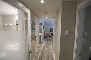 A hallway with a dining area at the end, featuring a table and chairs. - Stoney Creek Northstar 8 (Whistler)