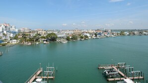 A marina with docked boats and a cityscape in the background.