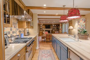 Enjoy cooking in this well-appointed kitchen with a stainless steel range hood, oven, and double sink.