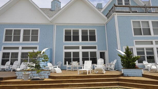 A two-story house with a covered patio area. - Almost Heaven: Colorful sunsets and views of Portsmouth Island. (Ocracoke)