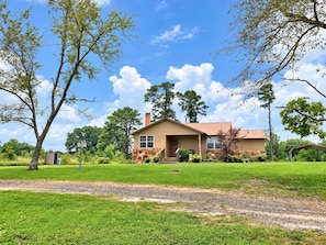 A single-story house with a front porch, a stone foundation, and a well-maintained lawn. - The Cottage is on 450 acres w/hot tub, Private 4wheeler trails (Hatfield)