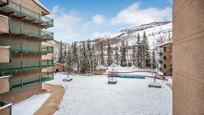 A snow-covered courtyard with a pool, surrounded by buildings with balconies. - 2 Bed / 2 Bath With Amazing Views Steps From Gondola (Vail)