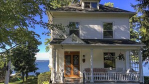 A two-story house with a porch, a front door, and a mailbox. - Lakefront Home in the Heart of Aurora, Sunset Ready! (Aurora)