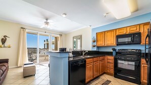 A modern kitchen with a dishwasher, stove, and microwave. - The Inn at Dauphin Island 106 1BR Walks right out to Pools and Beach! (Dauphin Island)