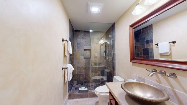 A bathroom with a glass shower enclosure, a toilet, a sink with a bowl, and a mirror. - Summit Condo 2815 - Sweet Penthouse with Great Views (Elkhorn)