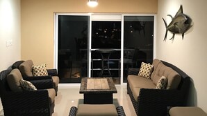 Un salon avec deux canapés, une table basse et un ventilateur de plafond.