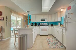 Fridge, microwave, oven, stovetop - Cozy Beach House w/ Backyard Pool & Steps to North Beach (Clearwater)