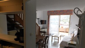 A room with a bed, a desk, a chair, a table, and a staircase. - F9 Large bright apartment, 3 rooms, beach at 50m, swimming pool and sea view  (Théoule Sur Mer)