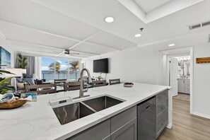 A modern kitchen with a large island, built-in appliances, and a view to the outdoors. - Beach Condo/ Island Beach Resort/No Cleaning Fee/ Condo 301 (Jensen Beach)