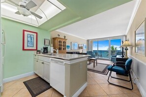 Relax in this inviting living area with a large island, ceiling fan, and comfortable seating.